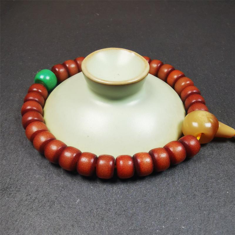 This bracelet mala was made by Tibetan craftsmen and come from Hepo Town, Baiyu County, the birthplace of the famous Tibetan handicrafts. It is made of Corypha Linn Seeds, diameter of 10mm / 0.4",circumference is 26cm / 10" ,with turquoise spacer bead, end of a yak horn guru bead.