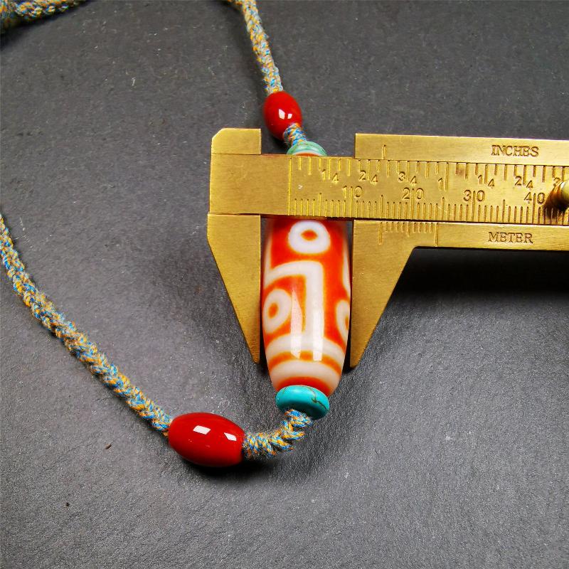 This necklace was hand-woven by Tibetans from Baiyu County, the main bead is a fire agate 9 eyes dzi, paired with 2 turquoise beads and 2 red agate beads,about 30 years old. The length of the necklace can be adjusted, the maximum circumference is about 60cm.