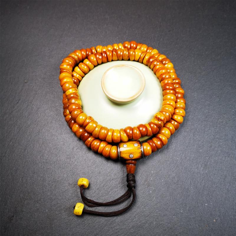 This mala was made by Tibetan craftsmen,about 30 years old. It is made of yak bone, yellow color,108 bevel cut beads diameter of 10mm / 0.4 inch,circumference is 50cm / 20 inches,1 guru bead and 2 dice pendant beads.