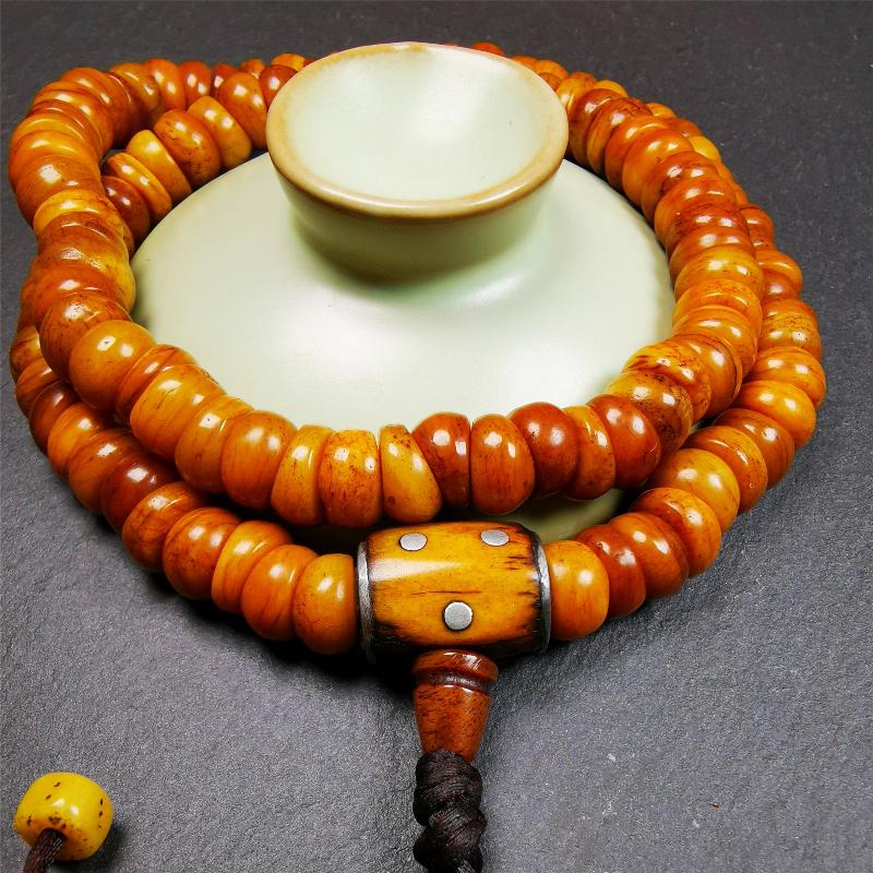 This mala was made by Tibetan craftsmen,about 30 years old. It is made of yak bone, yellow color,108 bevel cut beads diameter of 10mm / 0.4 inch,circumference is 50cm / 20 inches,1 guru bead and 2 dice pendant beads.