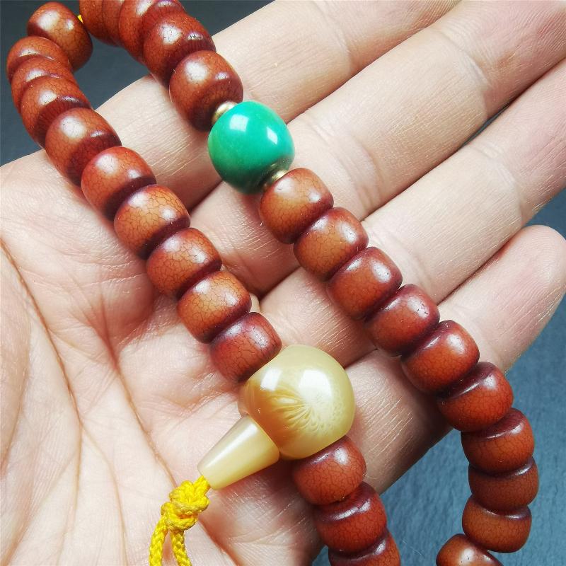 This bracelet mala was made by Tibetan craftsmen and come from Hepo Town, Baiyu County, the birthplace of the famous Tibetan handicrafts. It is made of Corypha Linn Seeds, diameter of 10mm / 0.4",circumference is 26cm / 10" ,with turquoise spacer bead, end of a yak horn guru bead.