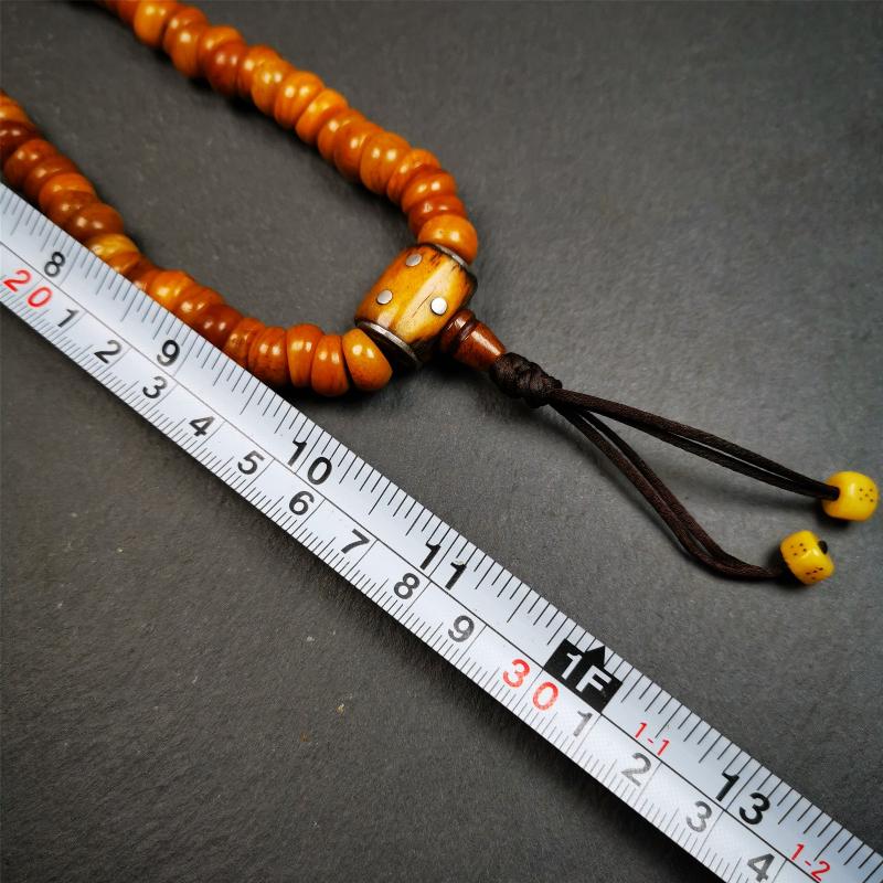 This mala was made by Tibetan craftsmen,about 30 years old. It is made of yak bone, yellow color,108 bevel cut beads diameter of 10mm / 0.4 inch,circumference is 50cm / 20 inches,1 guru bead and 2 dice pendant beads.