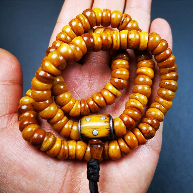 This mala was made by Tibetan craftsmen,about 30 years old. It is made of yak bone, yellow color,108 bevel cut beads diameter of 10mm / 0.4 inch,circumference is 50cm / 20 inches,1 guru bead and 2 dice pendant beads.