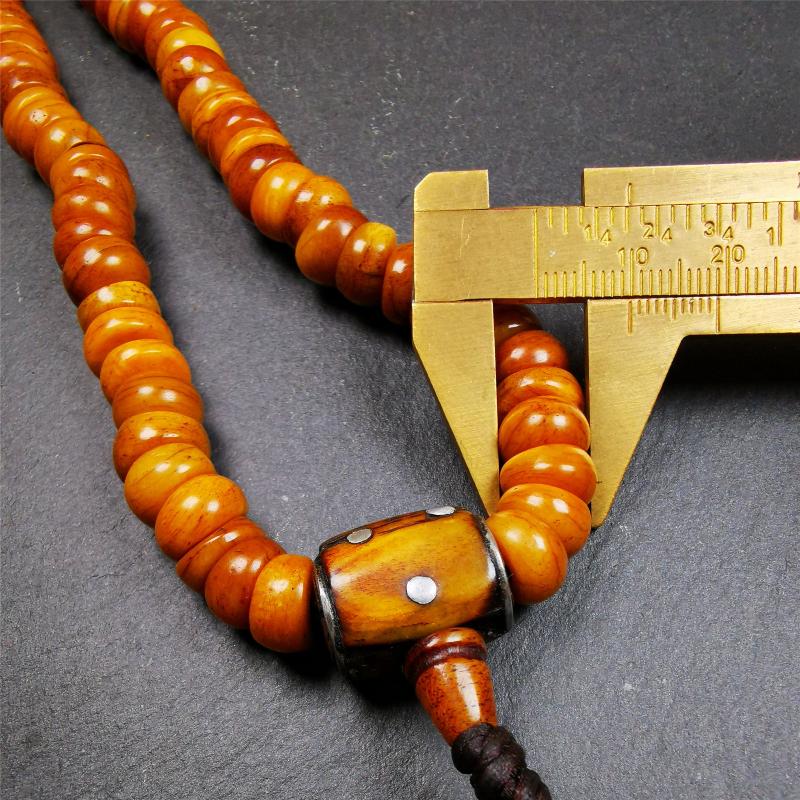 This mala was made by Tibetan craftsmen,about 30 years old. It is made of yak bone, yellow color,108 bevel cut beads diameter of 10mm / 0.4 inch,circumference is 50cm / 20 inches,1 guru bead and 2 dice pendant beads.