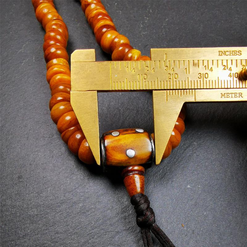 This mala was made by Tibetan craftsmen,about 30 years old. It is made of yak bone, yellow color,108 bevel cut beads diameter of 10mm / 0.4 inch,circumference is 50cm / 20 inches,1 guru bead and 2 dice pendant beads.