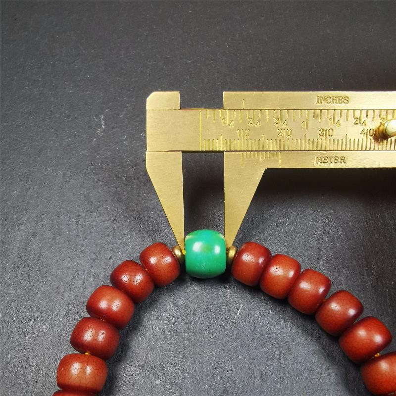 This bracelet mala was made by Tibetan craftsmen and come from Hepo Town, Baiyu County, the birthplace of the famous Tibetan handicrafts. It is made of Corypha Linn Seeds, diameter of 10mm / 0.4",circumference is 26cm / 10" ,with turquoise spacer bead, end of a yak horn guru bead.