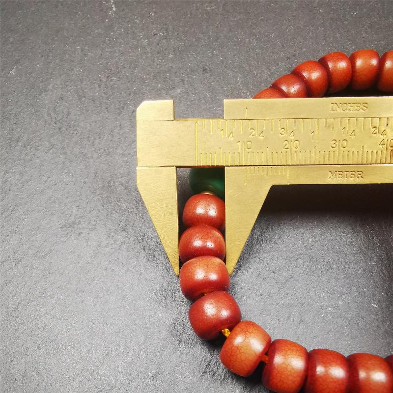 This bracelet mala was made by Tibetan craftsmen and come from Hepo Town, Baiyu County, the birthplace of the famous Tibetan handicrafts. It is made of Corypha Linn Seeds, diameter of 10mm / 0.4",circumference is 26cm / 10" ,with turquoise spacer bead, end of a yak horn guru bead.