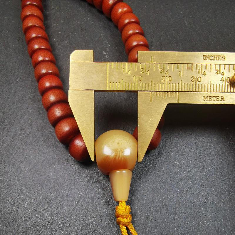 This bracelet mala was made by Tibetan craftsmen and come from Hepo Town, Baiyu County, the birthplace of the famous Tibetan handicrafts. It is made of Corypha Linn Seeds, diameter of 10mm / 0.4",circumference is 26cm / 10" ,with turquoise spacer bead, end of a yak horn guru bead.