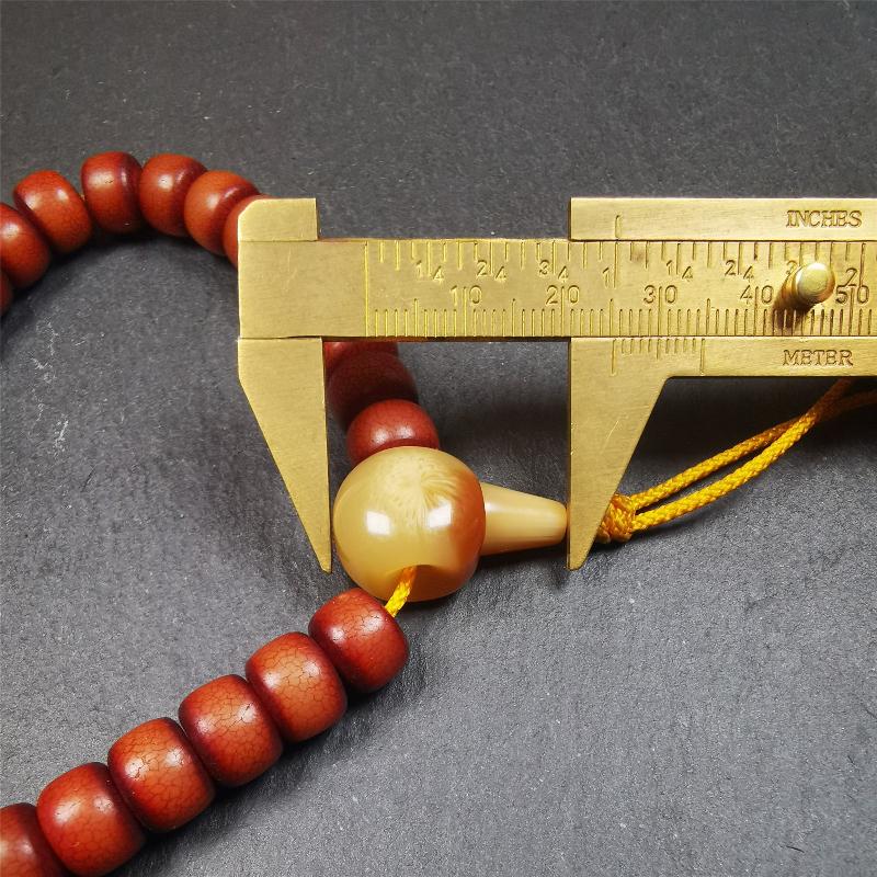 This bracelet mala was made by Tibetan craftsmen and come from Hepo Town, Baiyu County, the birthplace of the famous Tibetan handicrafts. It is made of Corypha Linn Seeds, diameter of 10mm / 0.4",circumference is 26cm / 10" ,with turquoise spacer bead, end of a yak horn guru bead.