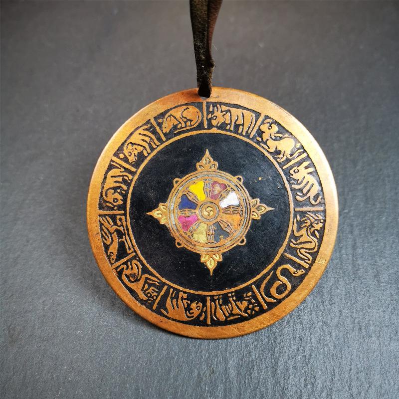 This beautiful prayer wheel badge was collected in Derge, Tibetan. It is made of brass, carved paryer wheel in the middle and Tibetan zodiac signs around it,then painted with color,size is 2.95". You can hang it at the door or in your shrine.