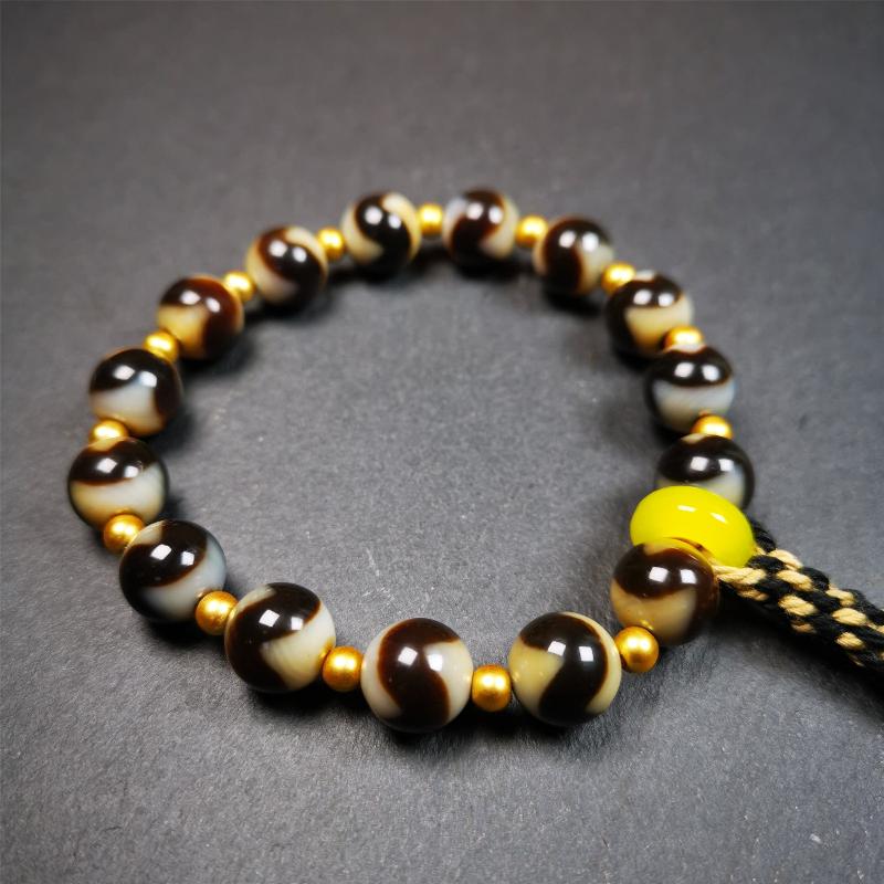 This tiger tooth dzi bracelet was hand-woven by Tibetans from Baiyu County,Tibet. It consists of 15 tiger tooth dzi beads and 15 spacer beads,tie with elastic cord to fit your wrist. Dzi beads are precious jewelry from Tibetan culture which are believed to possess the power of bringing good fortune to the owners. You'll get 1 dzi bracelet as pictures shown.