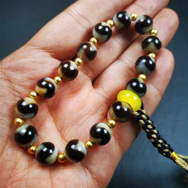 This tiger tooth dzi bracelet was hand-woven by Tibetans from Baiyu County,Tibet. It consists of 15 tiger tooth dzi beads and 15 spacer beads,tie with elastic cord to fit your wrist. Dzi beads are precious jewelry from Tibetan culture which are believed to possess the power of bringing good fortune to the owners. You'll get 1 dzi bracelet as pictures shown.
