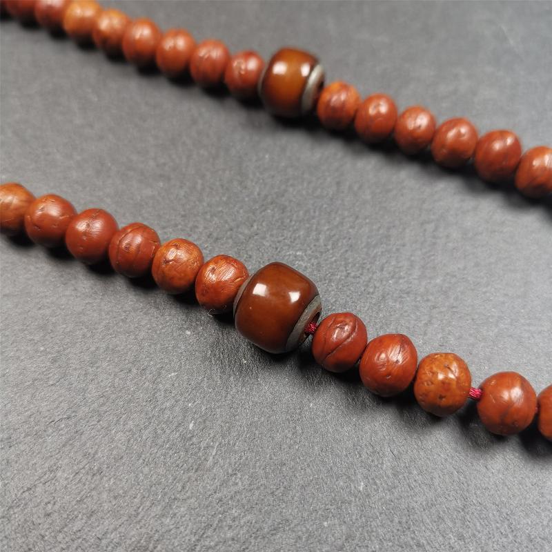These marker beads were handmade by Tibetan craftsmen and come from Hepo Town, Baiyu County, the birthplace of the famous Tibetan handicrafts. It is made of yak bone,inlaid cold iron,brown color,size is 0.47" × 0.4". Fit for 8-12mm mala (The reference in the photo is 9mm mala)
