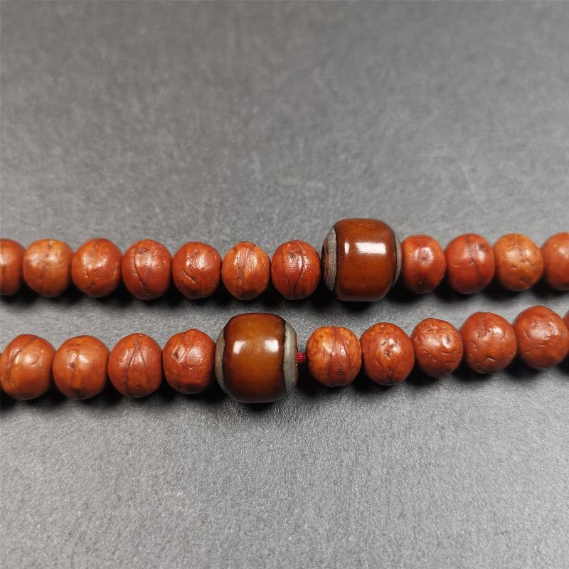 These marker beads were handmade by Tibetan craftsmen and come from Hepo Town, Baiyu County, the birthplace of the famous Tibetan handicrafts. It is made of yak bone,inlaid cold iron,brown color,size is 0.47" × 0.4". Fit for 8-12mm mala (The reference in the photo is 9mm mala)