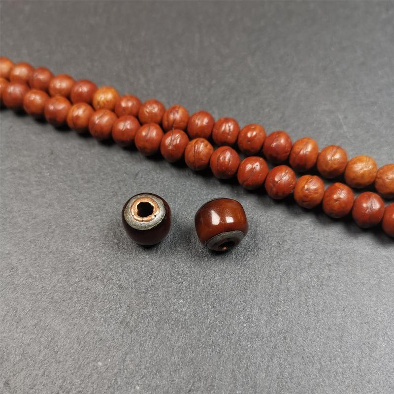 These marker beads were handmade by Tibetan craftsmen and come from Hepo Town, Baiyu County, the birthplace of the famous Tibetan handicrafts. It is made of yak bone,inlaid cold iron,brown color,size is 0.47" × 0.4". Fit for 8-12mm mala (The reference in the photo is 9mm mala)
