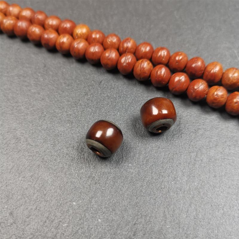 These marker beads were handmade by Tibetan craftsmen and come from Hepo Town, Baiyu County, the birthplace of the famous Tibetan handicrafts. It is made of yak bone,inlaid cold iron,brown color,size is 0.47" × 0.4". Fit for 8-12mm mala (The reference in the photo is 9mm mala)