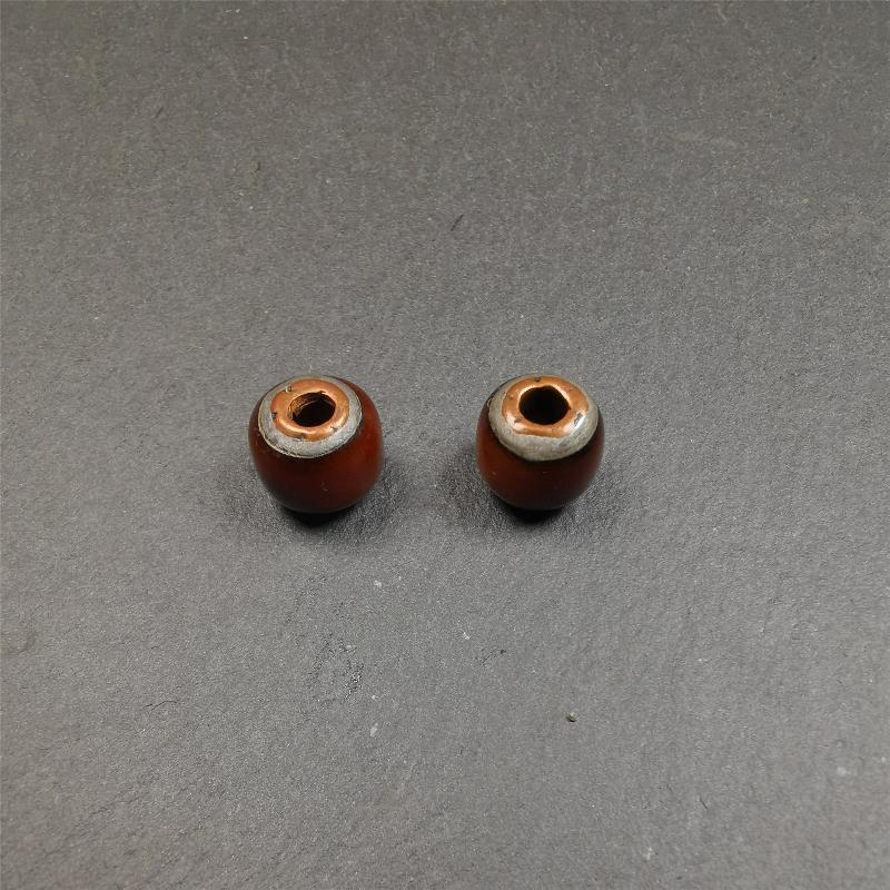 These marker beads were handmade by Tibetan craftsmen and come from Hepo Town, Baiyu County, the birthplace of the famous Tibetan handicrafts. It is made of yak bone,inlaid cold iron,brown color,size is 0.47" × 0.4". Fit for 8-12mm mala (The reference in the photo is 9mm mala)