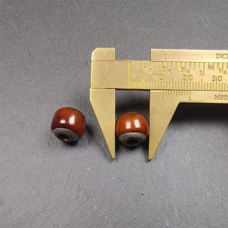 These marker beads were handmade by Tibetan craftsmen and come from Hepo Town, Baiyu County, the birthplace of the famous Tibetan handicrafts. It is made of yak bone,inlaid cold iron,brown color,size is 0.47" × 0.4". Fit for 8-12mm mala (The reference in the photo is 9mm mala)
