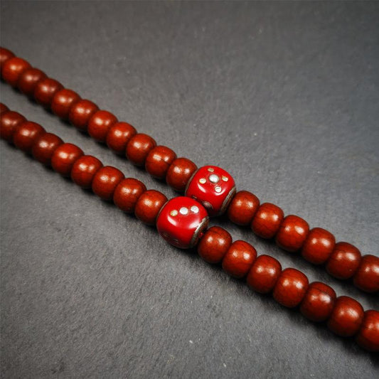 These marker beads were handmade by Tibetan craftsmen and come from Hepo Town, Baiyu County, the birthplace of the famous Tibetan handicrafts. It is made of plastic,inlaid cold iron,red color,size is 0.47" × 0.47". Fit for 8-12mm mala (The reference in the photo is 8mm mala)