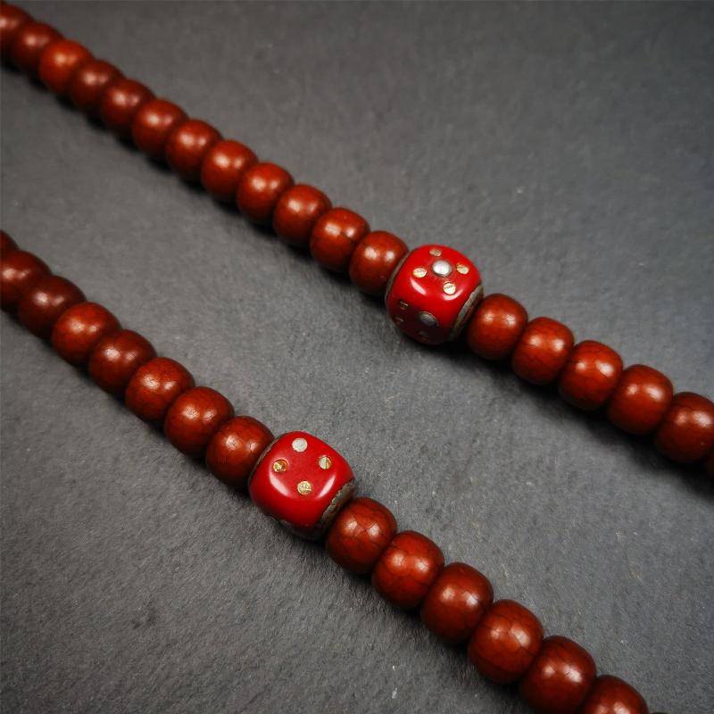 These marker beads were handmade by Tibetan craftsmen and come from Hepo Town, Baiyu County, the birthplace of the famous Tibetan handicrafts. It is made of plastic,inlaid cold iron,red color,size is 0.47" × 0.47". Fit for 8-12mm mala (The reference in the photo is 8mm mala)