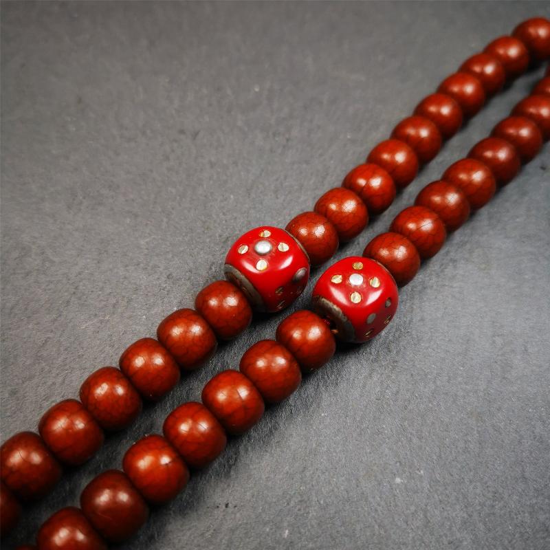 These marker beads were handmade by Tibetan craftsmen and come from Hepo Town, Baiyu County, the birthplace of the famous Tibetan handicrafts. It is made of plastic,inlaid cold iron,red color,size is 0.47" × 0.47". Fit for 8-12mm mala (The reference in the photo is 8mm mala)