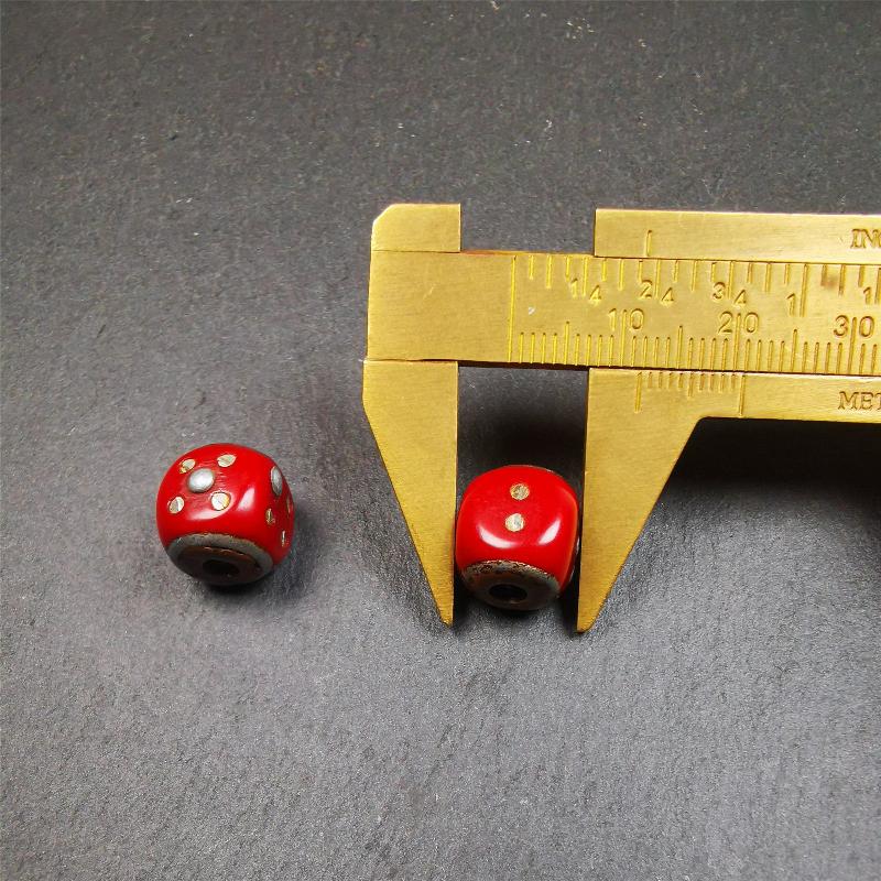 These marker beads were handmade by Tibetan craftsmen and come from Hepo Town, Baiyu County, the birthplace of the famous Tibetan handicrafts. It is made of plastic,inlaid cold iron,red color,size is 0.47" × 0.47". Fit for 8-12mm mala (The reference in the photo is 8mm mala)