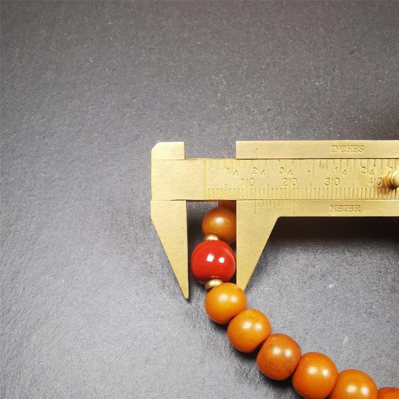 This mala was made by Tibetan craftsmen. It is made of Corypha Linn Seeds, diameter of 10mm / 0.4",circumference is 22cm / 8.7" ,with agate spacer bead, end of a white copper guru bead.