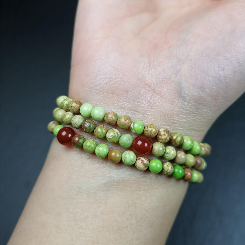 This small size turquoise mala was handmade from tibetan crafts man in Baiyu County. It's composed of 108 pcs 4mm turquoise beads, add 4 agate beads,string then with elastic cord and fit snugly around your wrist.