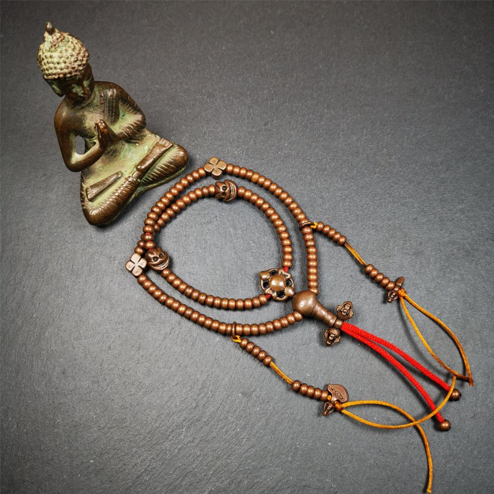 This mala was collect from Hepo Town Baiyu County Tibet, blessed in Yaqing Monastry. It is made of copper,brown color,length is 44cm / 18",has 1 Kartika ,2 skeletons, 2 stamp pendant, and 2 strings of counters with phurba + kartika.