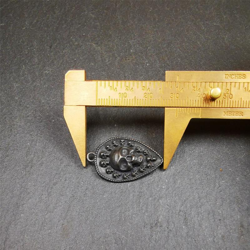 This skull vajra pendant was handmade by Tibetan craftsmen,it is made of thokcha, whole body is blcak,the front is skull and the back is vajra,size is 30mm × 18mm,comes with a black leather cord.