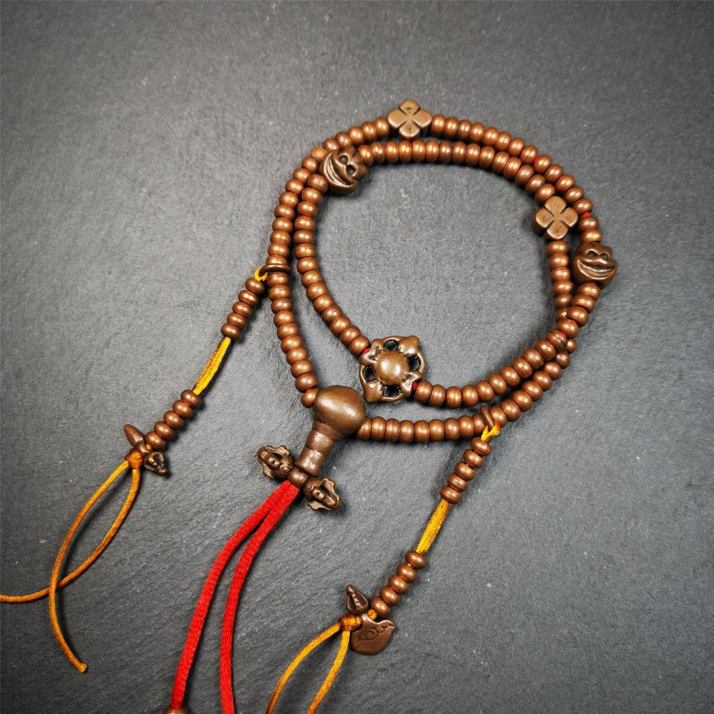 This mala was collect from Hepo Town Baiyu County Tibet, blessed in Yaqing Monastry. It is made of copper,brown color,length is 44cm / 18",has 1 Kartika ,2 skeletons, 2 stamp pendant, and 2 strings of counters with phurba + kartika.