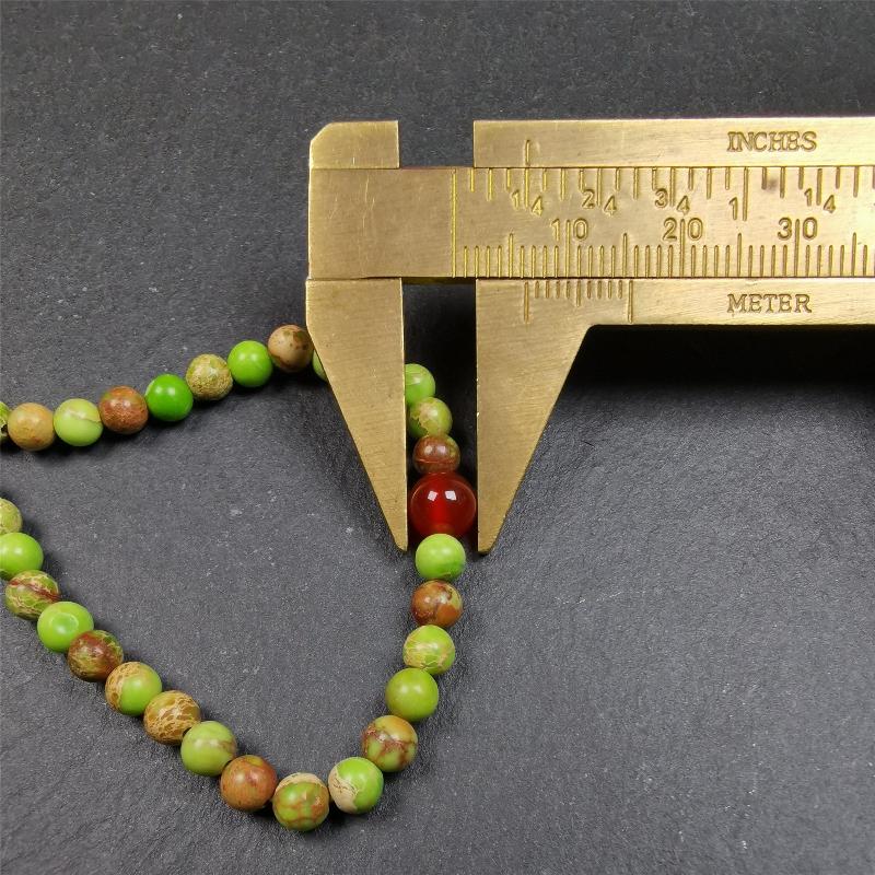 This small size turquoise mala was handmade from tibetan crafts man in Baiyu County. It's composed of 108 pcs 4mm turquoise beads, add 4 agate beads,string then with elastic cord and fit snugly around your wrist.