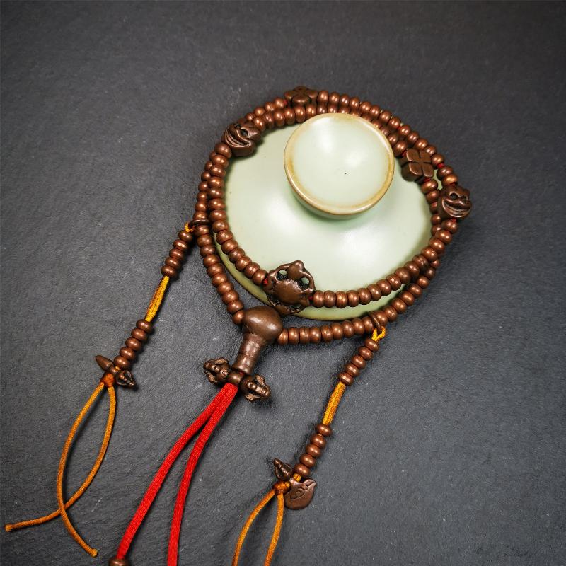 This mala was collect from Hepo Town Baiyu County Tibet, blessed in Yaqing Monastry. It is made of copper,brown color,length is 44cm / 18",has 1 Kartika ,2 skeletons, 2 stamp pendant, and 2 strings of counters with phurba + kartika.