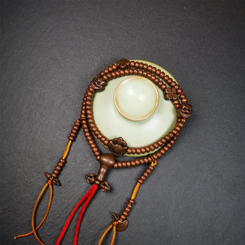This mala was collect from Hepo Town Baiyu County Tibet, blessed in Yaqing Monastry. It is made of copper,brown color,length is 44cm / 18",has 1 Kartika ,2 skeletons, 2 stamp pendant, and 2 strings of counters with phurba + kartika.