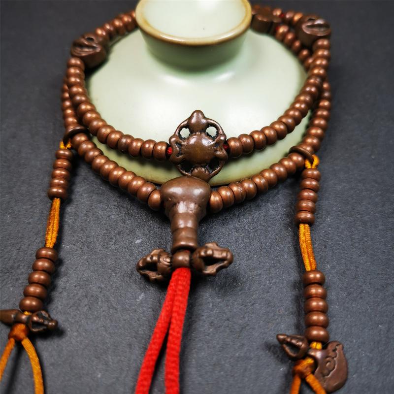 This mala was collect from Hepo Town Baiyu County Tibet, blessed in Yaqing Monastry. It is made of copper,brown color,length is 44cm / 18",has 1 Kartika ,2 skeletons, 2 stamp pendant, and 2 strings of counters with phurba + kartika.