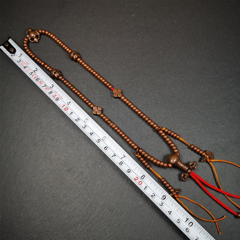 This mala was collect from Hepo Town Baiyu County Tibet, blessed in Yaqing Monastry. It is made of copper,brown color,length is 44cm / 18",has 1 Kartika ,2 skeletons, 2 stamp pendant, and 2 strings of counters with phurba + kartika.