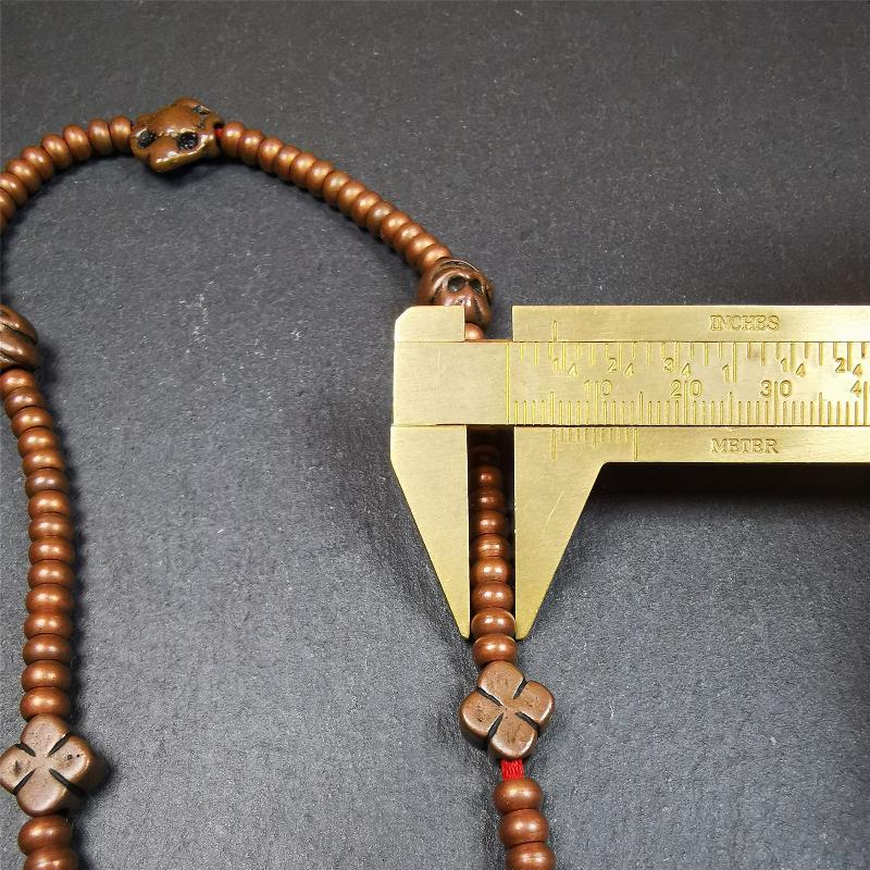 This mala was collect from Hepo Town Baiyu County Tibet, blessed in Yaqing Monastry. It is made of copper,brown color,length is 44cm / 18",has 1 Kartika ,2 skeletons, 2 stamp pendant, and 2 strings of counters with phurba + kartika.