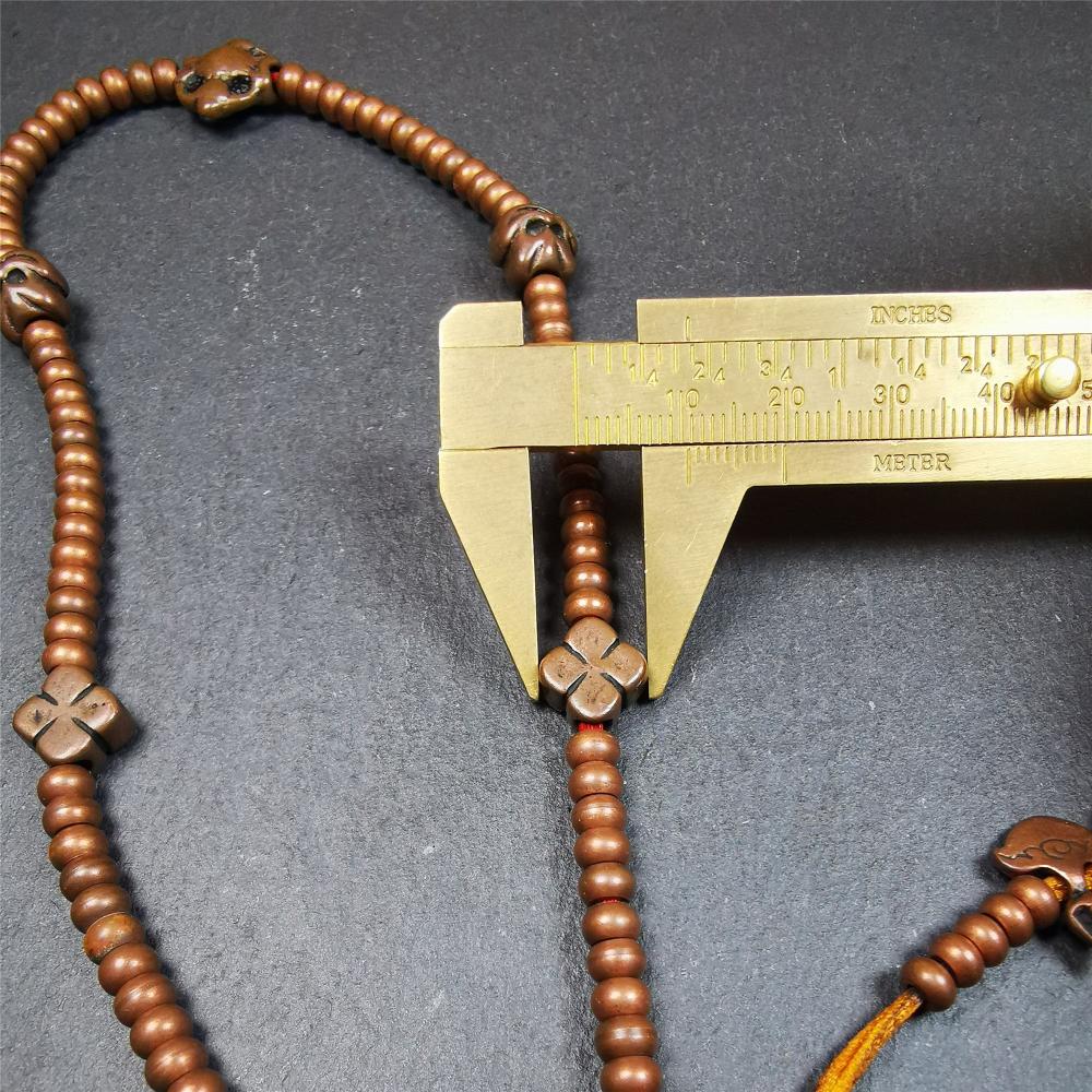 This mala was collect from Hepo Town Baiyu County Tibet, blessed in Yaqing Monastry. It is made of copper,brown color,length is 44cm / 18",has 1 Kartika ,2 skeletons, 2 stamp pendant, and 2 strings of counters with phurba + kartika.