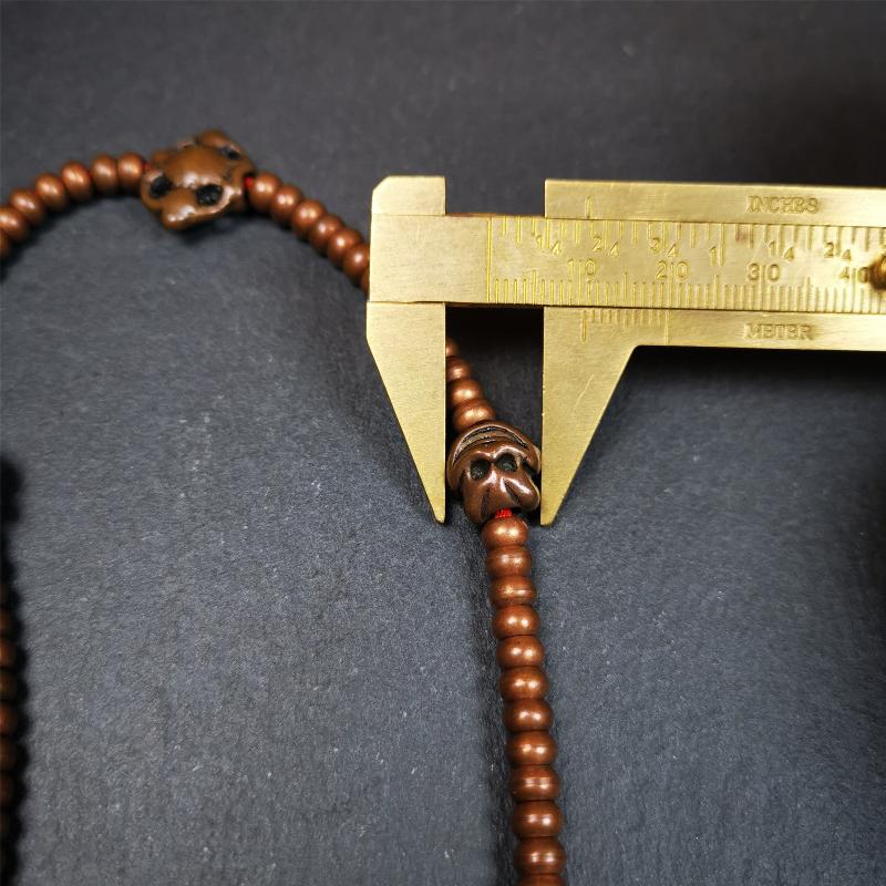 This mala was collect from Hepo Town Baiyu County Tibet, blessed in Yaqing Monastry. It is made of copper,brown color,length is 44cm / 18",has 1 Kartika ,2 skeletons, 2 stamp pendant, and 2 strings of counters with phurba + kartika.