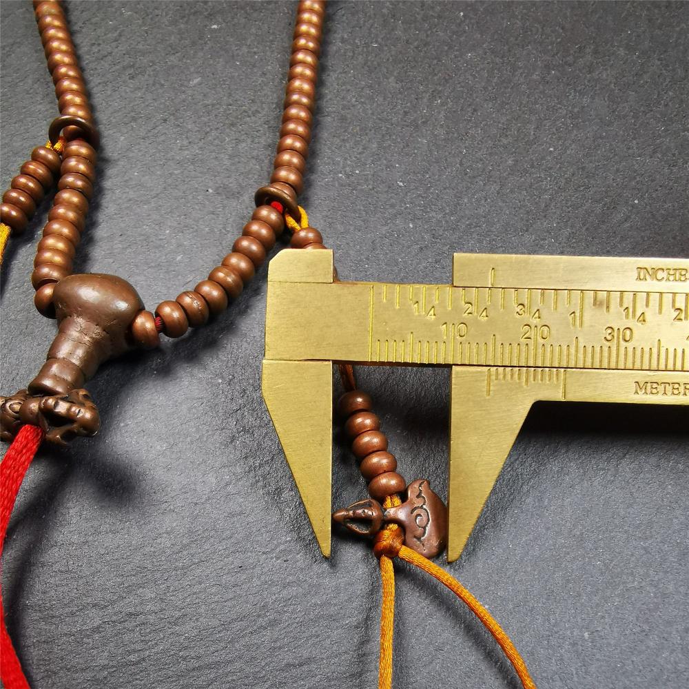 This mala was collect from Hepo Town Baiyu County Tibet, blessed in Yaqing Monastry. It is made of copper,brown color,length is 44cm / 18",has 1 Kartika ,2 skeletons, 2 stamp pendant, and 2 strings of counters with phurba + kartika.