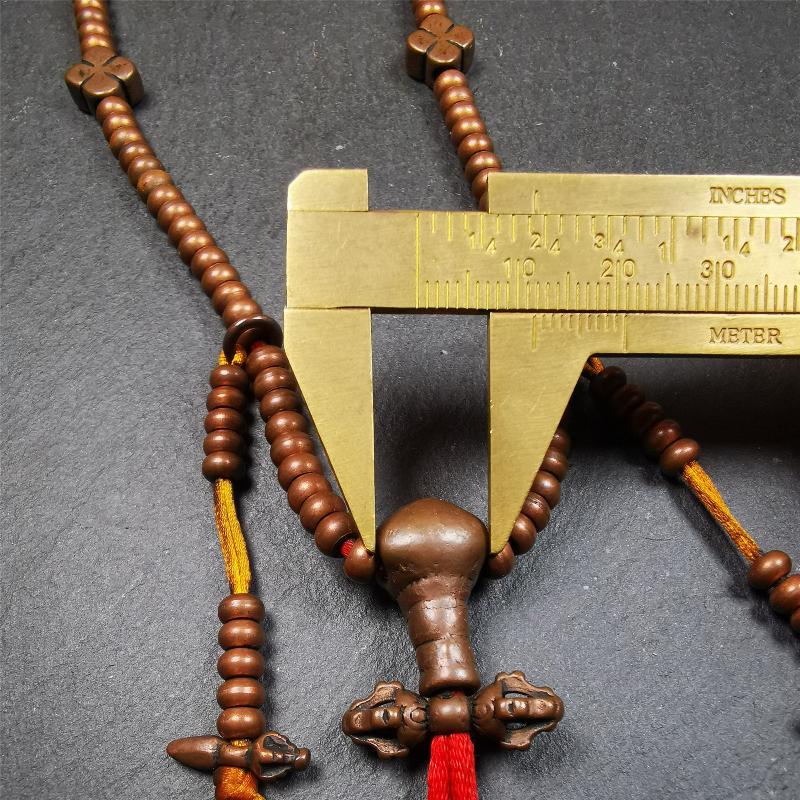 This mala was collect from Hepo Town Baiyu County Tibet, blessed in Yaqing Monastry. It is made of copper,brown color,length is 44cm / 18",has 1 Kartika ,2 skeletons, 2 stamp pendant, and 2 strings of counters with phurba + kartika.