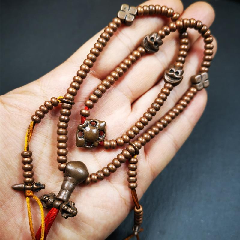 This mala was collect from Hepo Town Baiyu County Tibet, blessed in Yaqing Monastry. It is made of copper,brown color,length is 44cm / 18",has 1 Kartika ,2 skeletons, 2 stamp pendant, and 2 strings of counters with phurba + kartika.