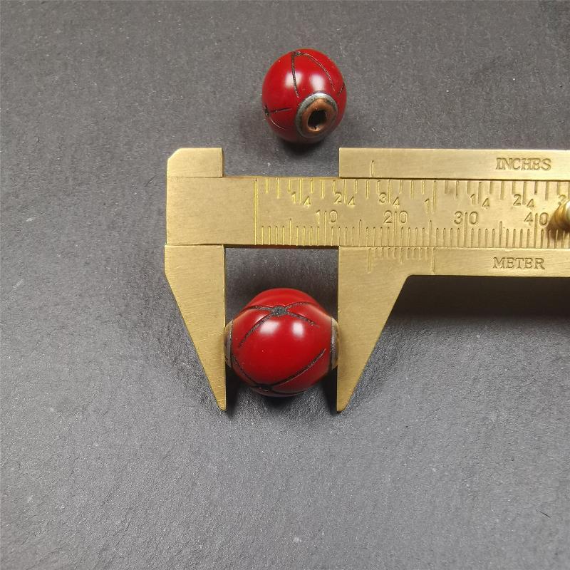 These marker beads were handmade by Tibetan craftsmen. It is made of plastic,inlaid copper and cold iron,red color,size is 0.6" × 0.6". Fit for 8-15mm mala (The reference in the photo is 8mm mala)