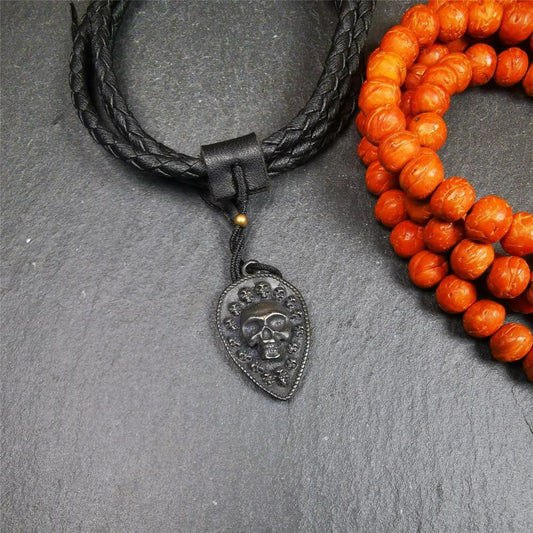 This skull vajra pendant was handmade by Tibetan craftsmen,it is made of thokcha, whole body is blcak,the front is skull and the back is vajra,size is 30mm × 18mm,comes with a black leather cord.