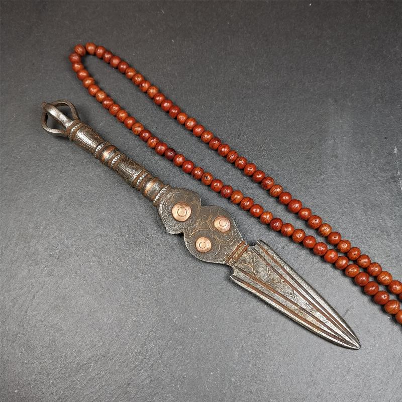 This phurba kila is handmade by Tibetan craftsmen from Tibet in 1990s. It's a kila dagger, phurba,made of cold iron, carved cloud pattern, inlaid red copper, and the half vajra on the handle,8.7 inches length.