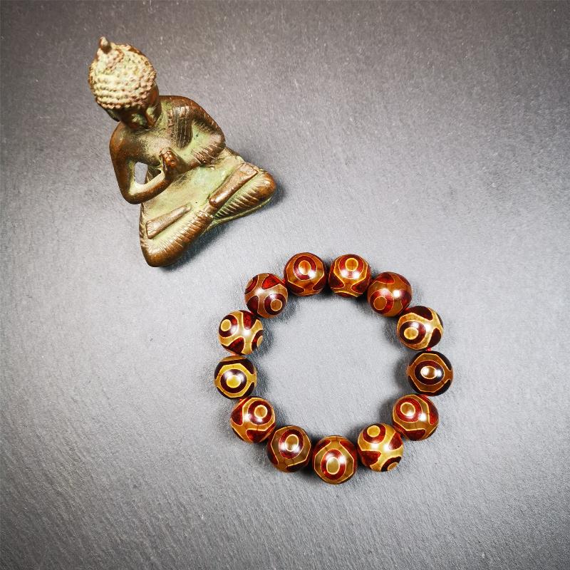 This 3 eyes bracelet was hand-woven by Tibetans,It's made of 3 eyes round dzi beads,brown color,diameter is 0.63", the circumference of bracelet is 7.5". It can be worn not only as a fashionable accessory but also holds cultural and religious significance.