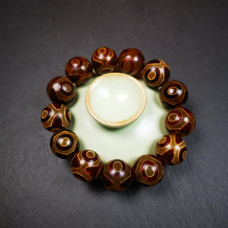 This 3 eyes bracelet was hand-woven by Tibetans,It's made of 3 eyes round dzi beads,brown color,diameter is 0.63", the circumference of bracelet is 7.5". It can be worn not only as a fashionable accessory but also holds cultural and religious significance.