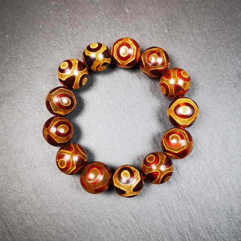 This 3 eyes bracelet was hand-woven by Tibetans,It's made of 3 eyes round dzi beads,brown color,diameter is 0.63", the circumference of bracelet is 7.5". It can be worn not only as a fashionable accessory but also holds cultural and religious significance.