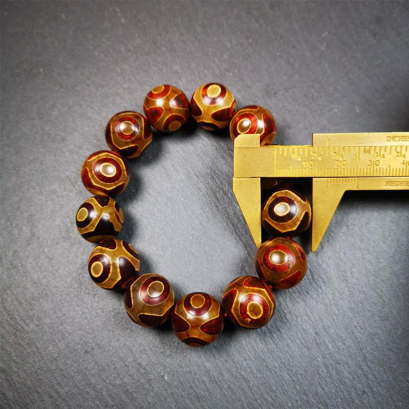 This 3 eyes bracelet was hand-woven by Tibetans,It's made of 3 eyes round dzi beads,brown color,diameter is 0.63", the circumference of bracelet is 7.5". It can be worn not only as a fashionable accessory but also holds cultural and religious significance.