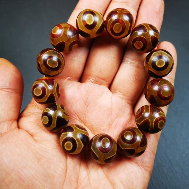This 3 eyes bracelet was hand-woven by Tibetans,It's made of 3 eyes round dzi beads,brown color,diameter is 0.63", the circumference of bracelet is 7.5". It can be worn not only as a fashionable accessory but also holds cultural and religious significance.